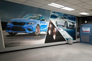 Wall wrap graphic of BMW cars, displayed in the UTI building.