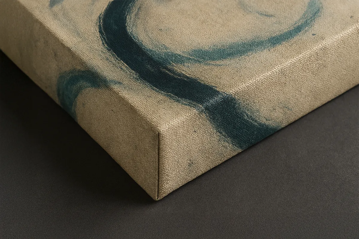 Detail shot of a stretched canvas print showing texture and a visible brushstroke in deep blue on natural linen material.