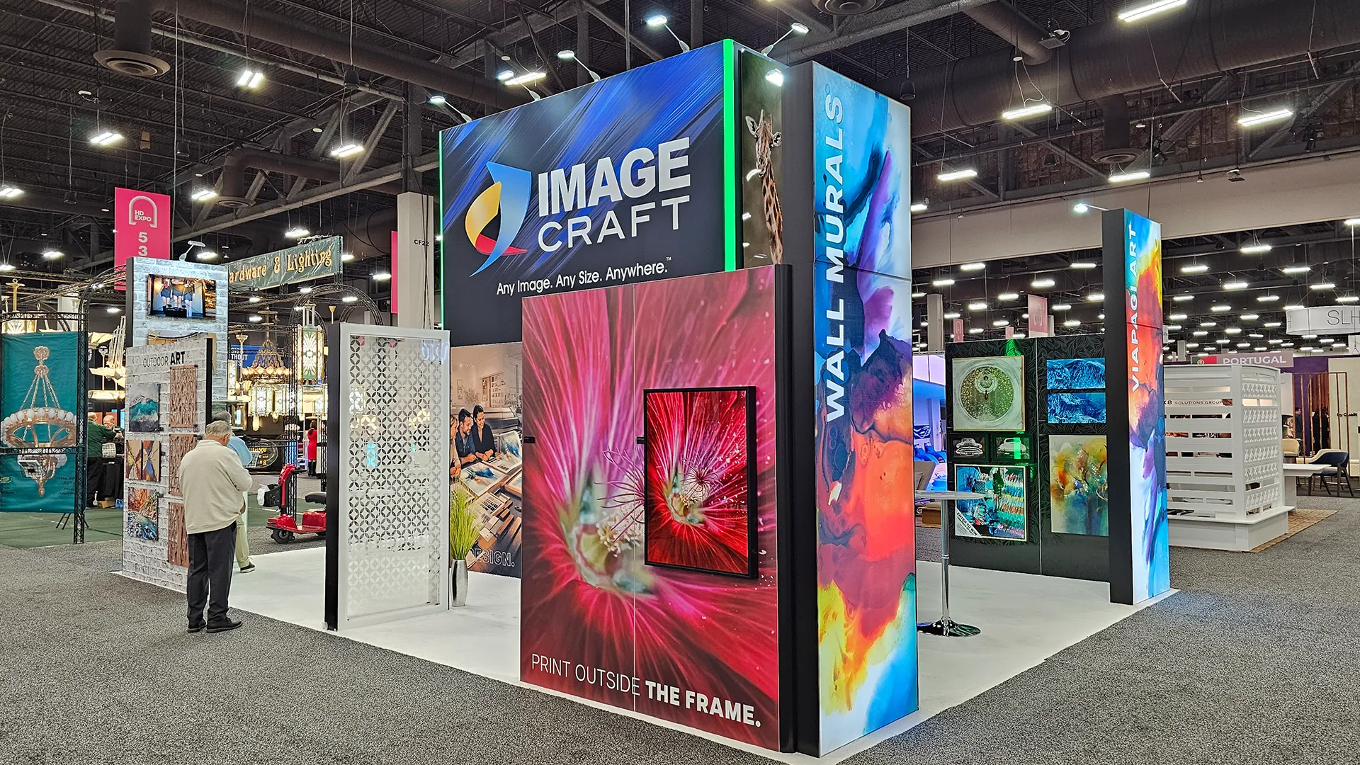 Image Craft exhibit booth showcasing custom wall murals, framed art, acoustic panels, and large-format printed displays at a hospitality industry trade show.