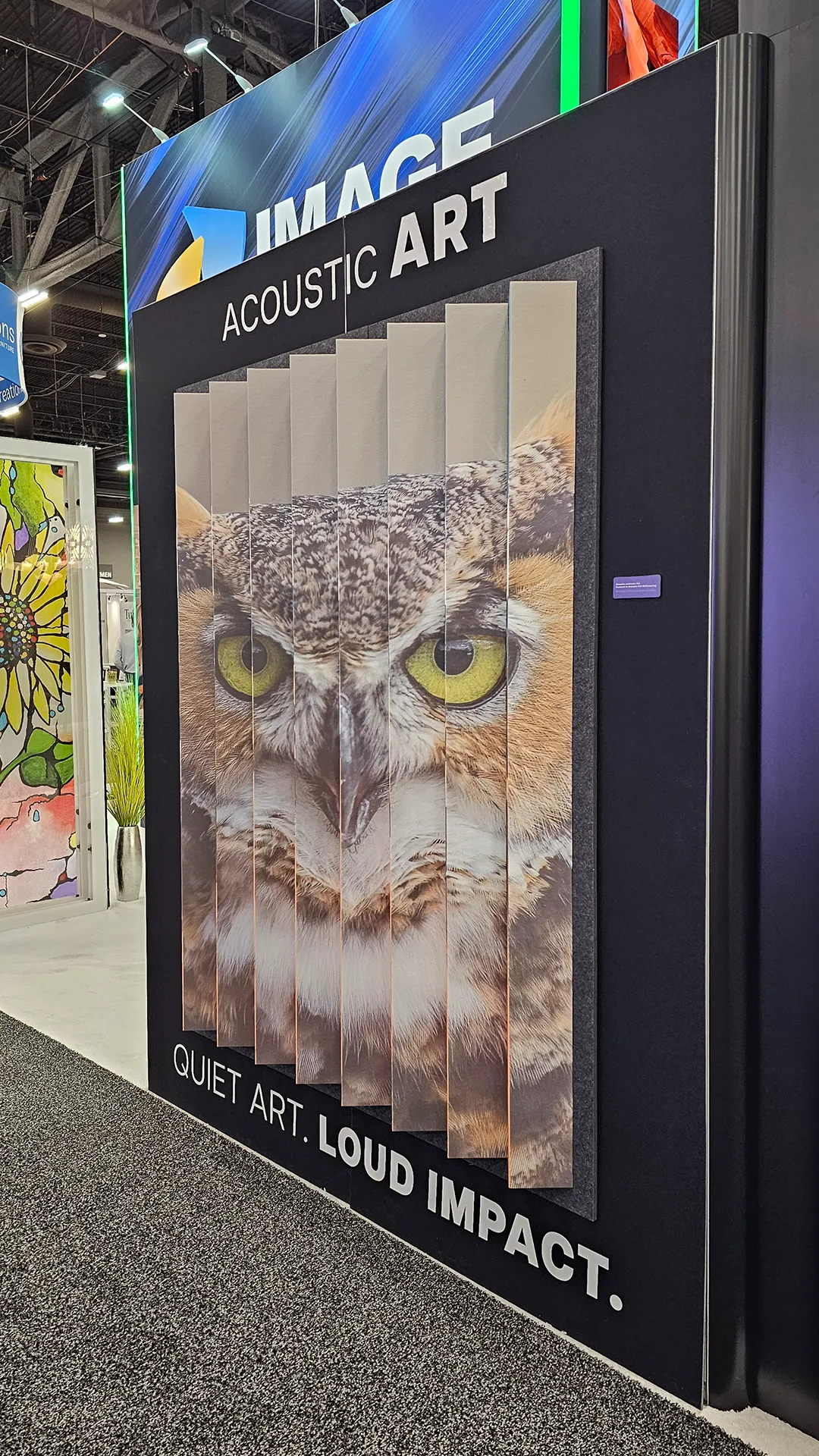Acoustic art panel display featuring layered owl artwork with dimensional printed panels at the Image Craft trade show booth.