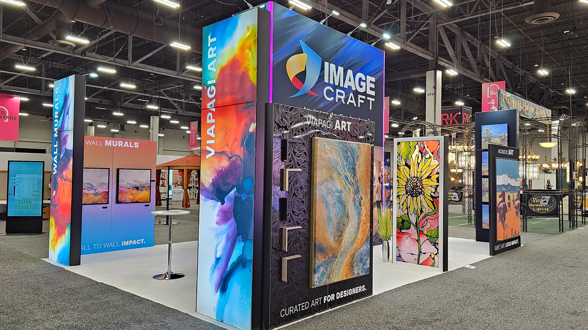 Image Craft trade show display featuring Viapagi Art, wall murals, acoustic art panels, and colorful large-format graphics at an interior design expo.
