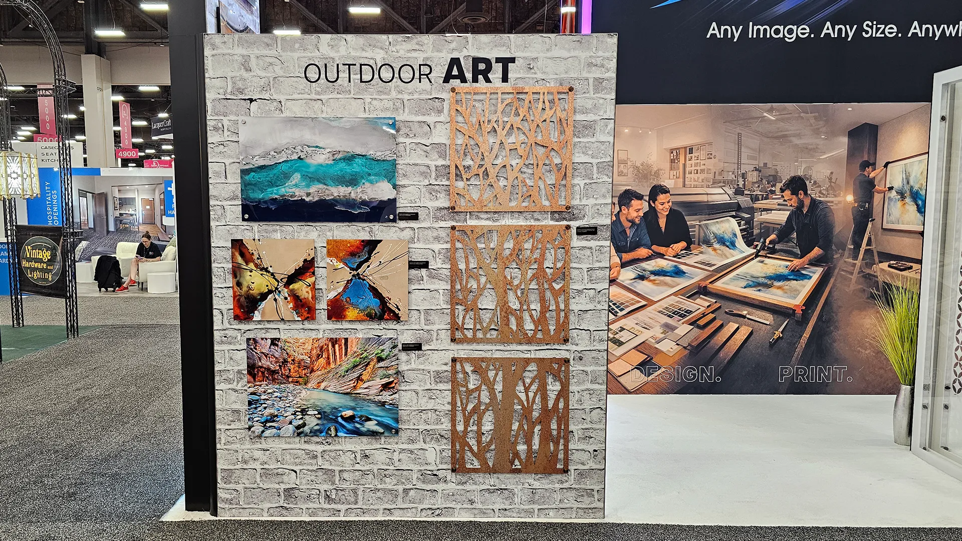 Outdoor art display featuring weather-resistant printed artwork, decorative metal panels, and textured wall décor at the Image Craft trade show booth.