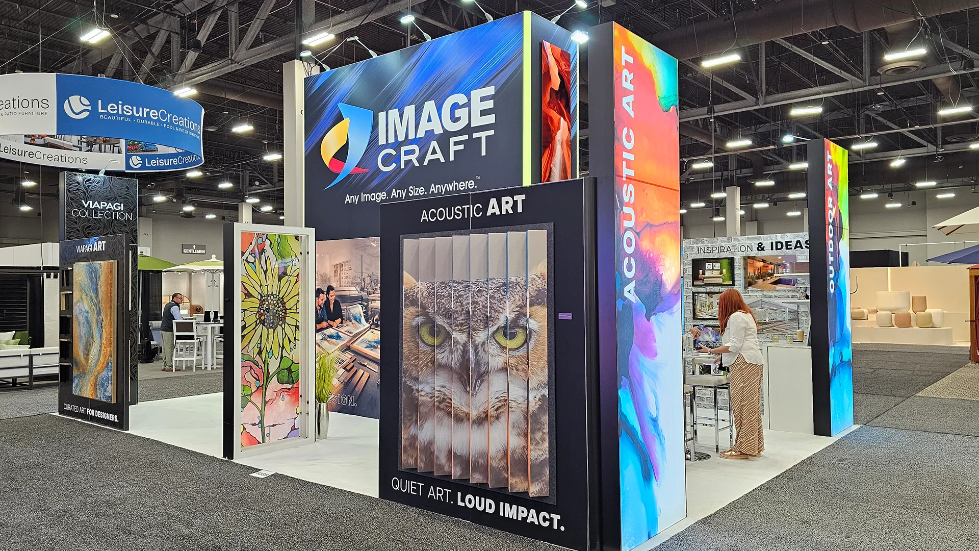 Image Craft booth featuring acoustic art panels, custom wall décor, and large-format printed artwork displays at a hospitality and design trade show.