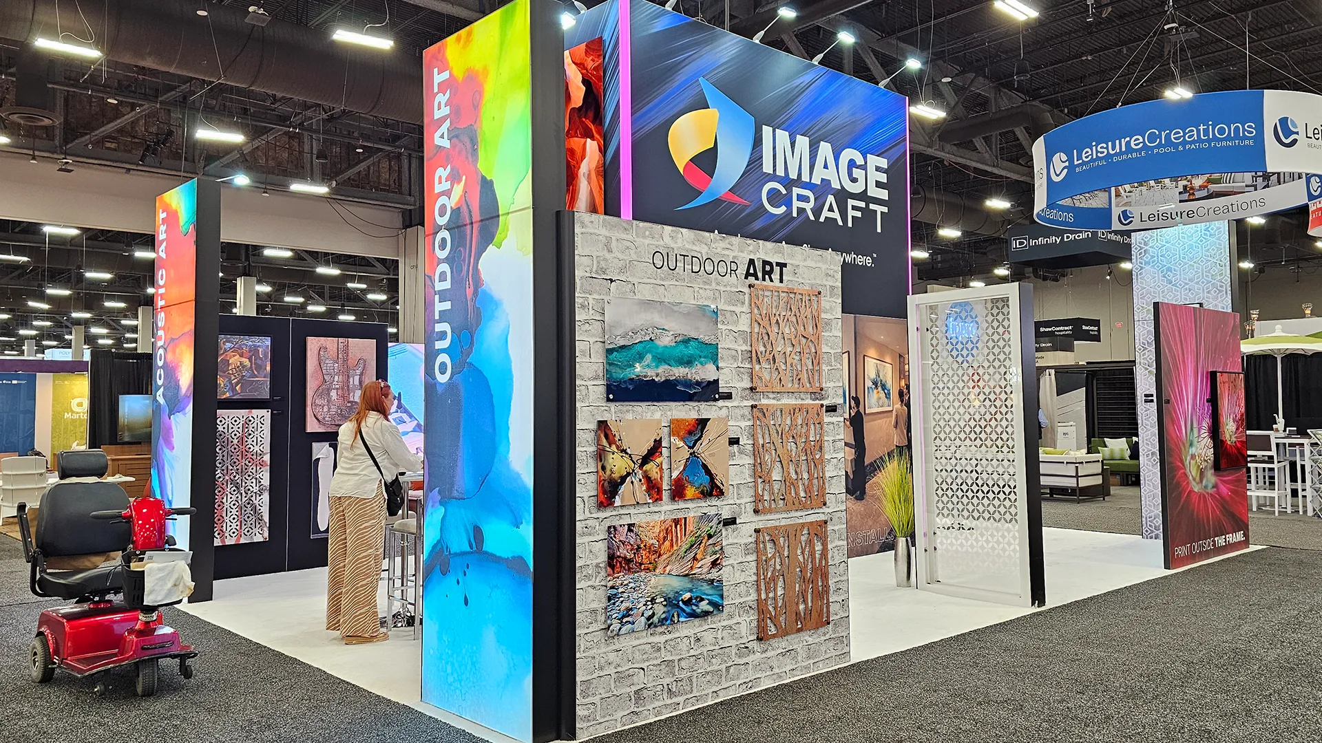 Image Craft trade show booth displaying outdoor art, acoustic panels, decorative screens, and large-format printed graphics for hospitality and commercial spaces.
