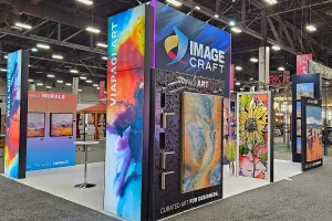 Image Craft trade show booth featuring large-format wall murals, acoustic art panels, and vibrant custom printed artwork displays at an industry expo.