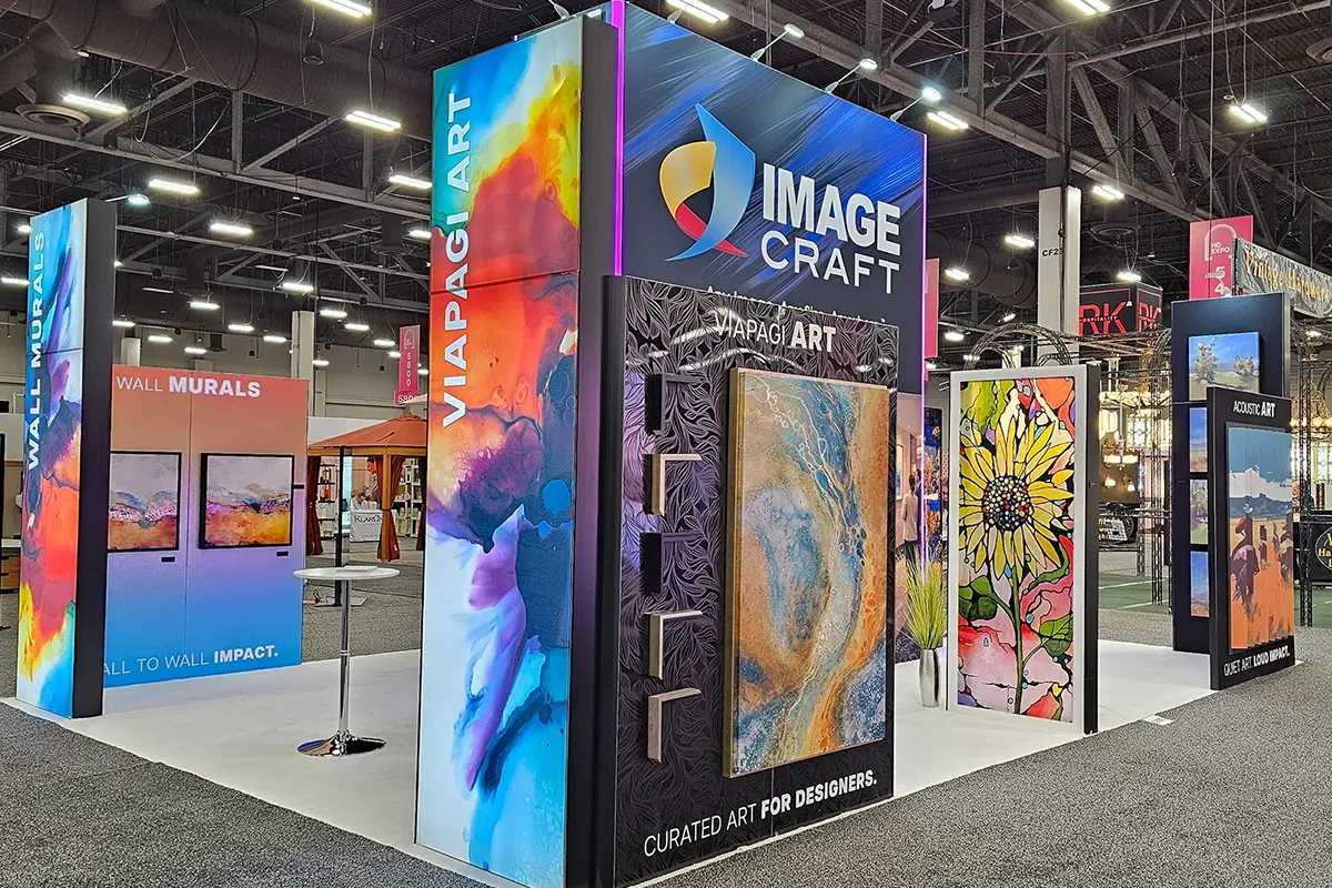 Image Craft trade show booth featuring large-format wall murals, acoustic art panels, and vibrant custom printed artwork displays at an industry expo.