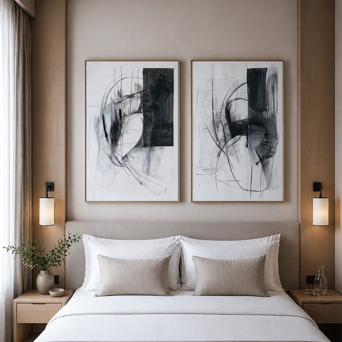 Two custom framed abstract black and white art prints displayed above a hotel bed in a modern hospitality guest room.