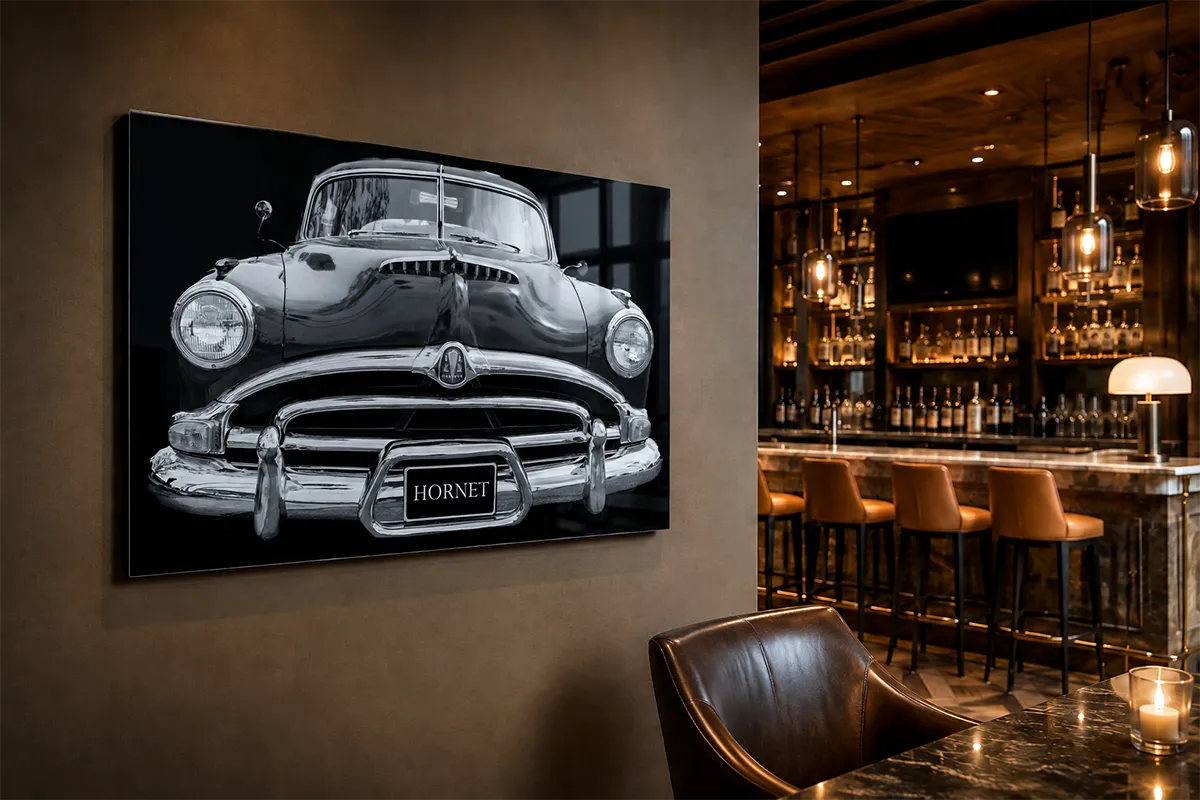 Black-and-white classic car acrylic wall art installed in an upscale bar and hospitality interior