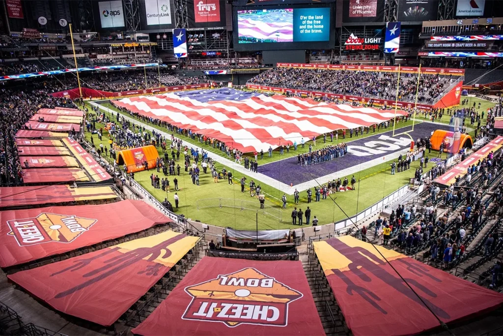 Cheez-It Bowl football stadium featuring large-format field tunnel covers and event graphics