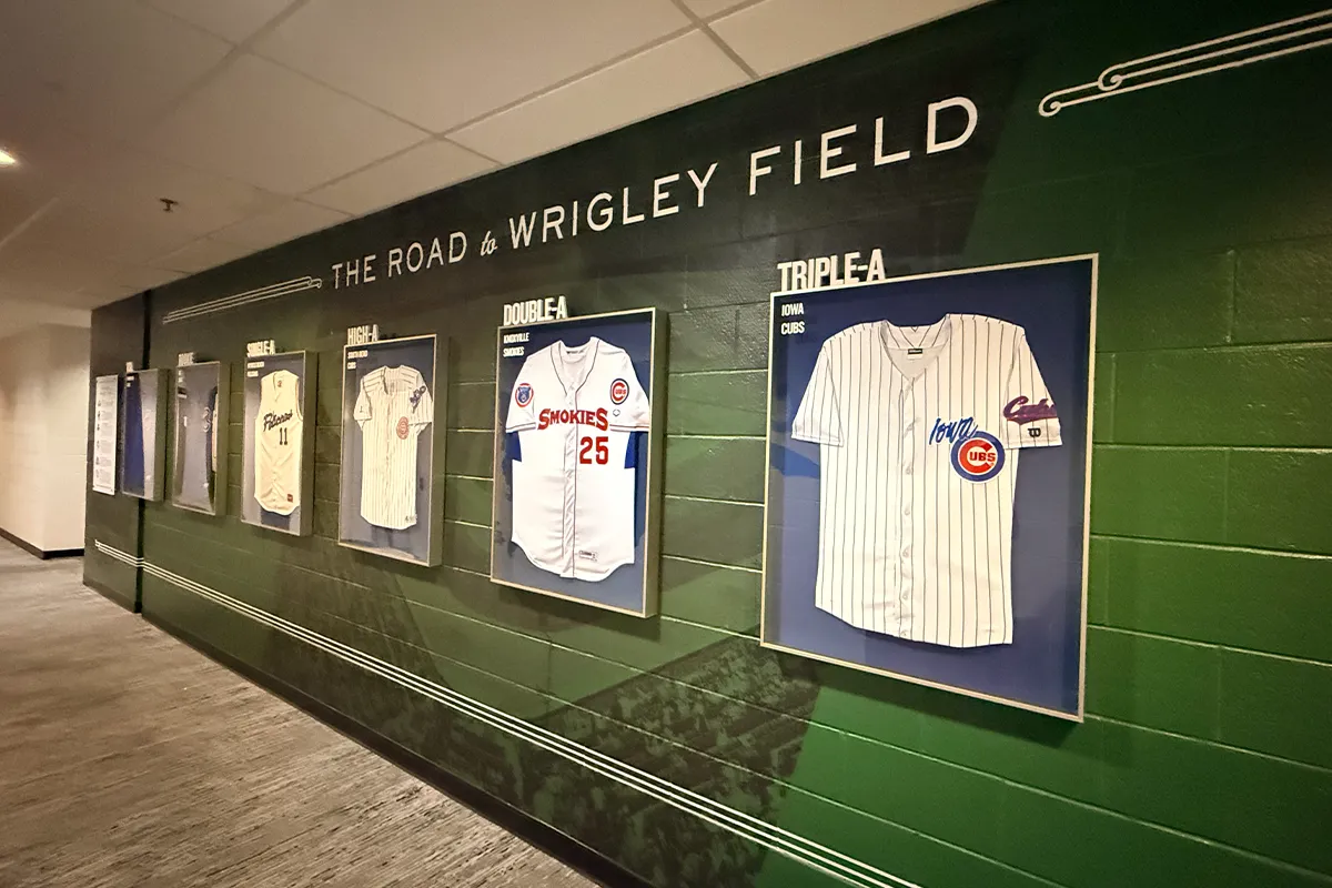 Chicago Cubs Sloan Park training facility hallway with framed jerseys and custom wall graphics